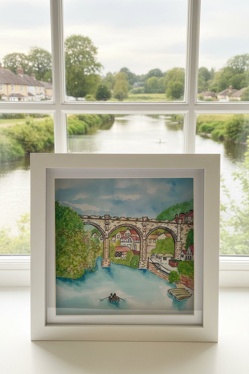 Framed artwork of the famous viaduct in Knaresborough, set against a scenic background.